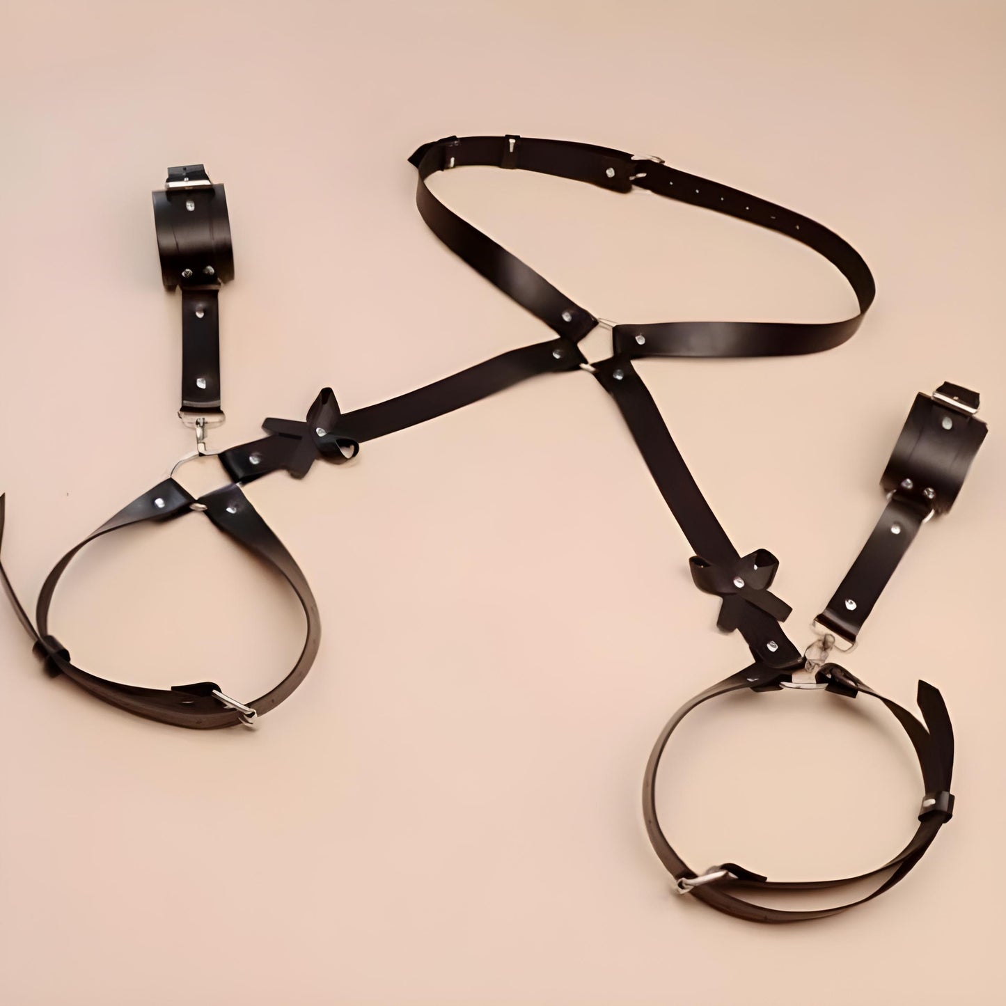 Black body harness with wrist cuffs laid flat.